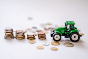a toy tractor near the coins
